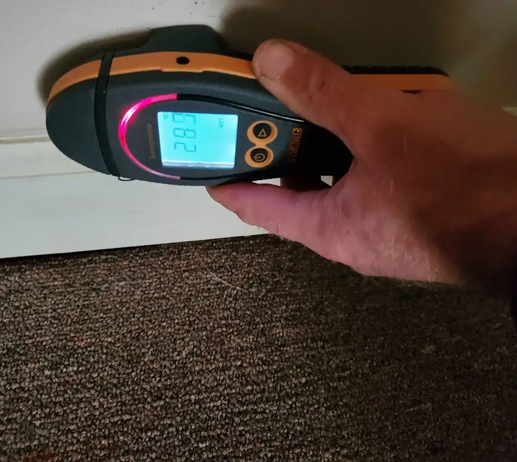 Moisture detection at baseboard during Storm Damage Restoration in Beverly